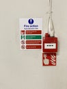 Fire action plan sign and manual fire alarm point in public work place Royalty Free Stock Photo