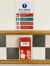 Fire action plan sign and manual fire alarm point in public work place Royalty Free Stock Photo