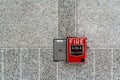 Fire alarm box on granite wall for warning Royalty Free Stock Photo