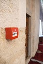 Fire alarm box on a stone wall in a historic building Royalty Free Stock Photo