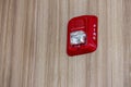 A fire alarm with built in strobe light to alert in case of fire. A sound and strobe fire alarm is mounted to an interior wall as Royalty Free Stock Photo