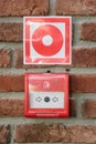 Fire alarm button in emergency system over a wall. Fire alert. Royalty Free Stock Photo