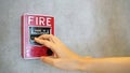 Fire alarm notifier or alert or bell warning equipment and hand use when on fire Royalty Free Stock Photo