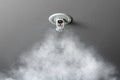 Fire alarm sprinkler system in action with smoke Royalty Free Stock Photo