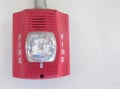 Fire alarm with strobe light on white background
