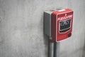 Fire alarm switch on the concrete wall in building for safety with copy space for text. Royalty Free Stock Photo