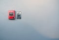 Fire alarm on white concrete wall. Warning and security system. Emergency equipment for safety alert. Red box of fire alarm Royalty Free Stock Photo