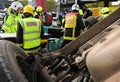 Fire and ambulance crews with overturned car Royalty Free Stock Photo