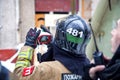 A firefighter stands with a thermal imager