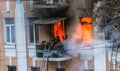 A fire in an apartment building. Strong bright light and clubs, smoke clouds window of their burning house. Firefighters