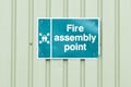 Fire assembly point sign on green container construction site