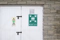 Fire assembly point sign at workplace car park wall Royalty Free Stock Photo