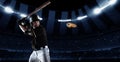 Poster with professional baseball player with baseball bat in action during match in crowed sport stadium at evening Royalty Free Stock Photo