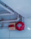 Fire Bell Alarm (red) and pipeline on the wall