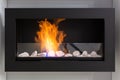 Fire in a bio fireplace working on ethanol fuel mounted on the wall Royalty Free Stock Photo