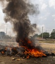 Fire Blazing in Middle of Street, A raging fire blazes in the middle of a street, engulfing the surrounding area in flames and Royalty Free Stock Photo