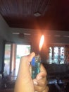 Fire blue lighter in my brown hand Royalty Free Stock Photo