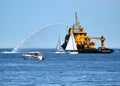 Fire-boat in action spraying water on the sea and having fun.