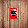 Fire break glass switch on Wooden wall background Royalty Free Stock Photo