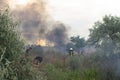 A fire brigade on a fire engine extinguishes a forest fire. Inscriptions on the car in Russian - fire truck and Odessa. 2019. 06. Royalty Free Stock Photo