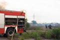 A fire brigade on a fire engine extinguishes a forest fire. Inscriptions on the car in Russian - fire truck and Odessa. 2019. 06.