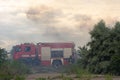 A fire brigade on a fire engine extinguishes a forest fire. Inscriptions on the car in Russian - fire truck and Odessa. 2019. 06. Royalty Free Stock Photo