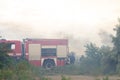 A fire brigade on a fire engine extinguishes a forest fire. Inscriptions on the car in Russian - fire truck and Odessa. 2019. 06. Royalty Free Stock Photo