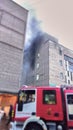 Fire in the building on the third and fourth floor, the fire brigade begins to extinguish Royalty Free Stock Photo