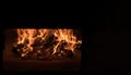 Fire and burn coals in stone oven. Oven made of brick and clay on the wood. Oven for pizza Royalty Free Stock Photo