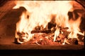 Fire and burn coals in stone oven. Oven made of brick and clay on the wood. Oven for pizza Royalty Free Stock Photo