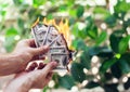 Fire burn one hundred dollars in hand Royalty Free Stock Photo