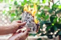 Fire burn one hundred dollars in hand Royalty Free Stock Photo