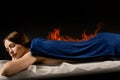 Fire burning on back therapy massage of girl. Fire massage of back in spa. Chinese Huo Liao therapy for young woman in