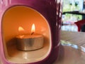 Fire burning candle in ceramic pot Royalty Free Stock Photo
