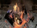 A fire is burning in the fireplace, close-up. Burning wood in the fireplace creates comfort in the house. The warmth of the