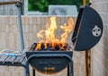 Fire burning high in a stove. Outdoor barbecue cooking on a picnic at summer Royalty Free Stock Photo