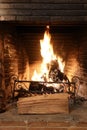 Fire burning in old fireplace with charred bricks Royalty Free Stock Photo