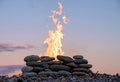 The fire burning in the stone place on the pebbly beach Royalty Free Stock Photo