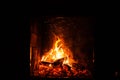 A fire burns in a fireplace, close up shot of burning firewood in the fireplace Royalty Free Stock Photo