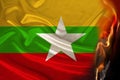 fire burns on the national flag of the state of Myanmar on silk the concept of tourism politics military coup revolution