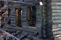 After fire - burnt house. Black burned wooden walls