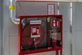 Fire cabinet complete with fire extinguisher, faucet and hose Royalty Free Stock Photo