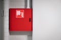 Fire cabinet with extinguisher and hydrant hose on white wall background. Firefighters and rescue safety equipment and emergency