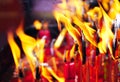 Fire on candles after Buddhist praying in the temple