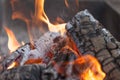 Fire with charcoals. Burning wood. Macro. Live flames with smoke. Wood with flame for barbecue and cooking bbq. Bright color. Royalty Free Stock Photo