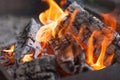 Fire with charcoals. Burning wood. Macro. Live flames with smoke. Wood with flame for barbecue and cooking bbq. Bright color. Royalty Free Stock Photo