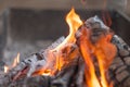 Fire with charcoals. Burning wood. Macro. Live flames with smoke. Wood with flame for barbecue and cooking bbq. Bright color. Royalty Free Stock Photo