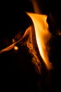 Fire close-up and red orange yellow color detail texture and abstract shape on black background Royalty Free Stock Photo