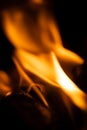 Fire close-up and red orange yellow color detail texture and abstract shape on black background Royalty Free Stock Photo