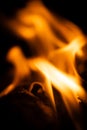 Fire close-up and red orange yellow color detail texture and abstract shape on black background Royalty Free Stock Photo